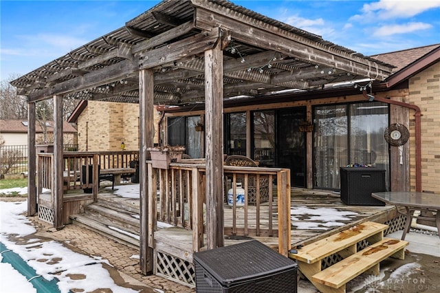 snow covered deck with a pergola