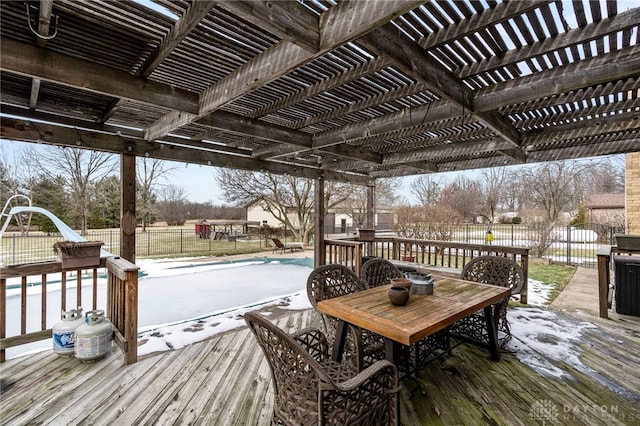 snow covered deck with a pergola and a covered pool