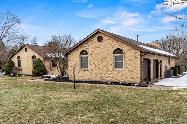 view of side of home with a garage, central AC, and a lawn