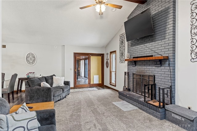 carpeted living room featuring lofted ceiling with beams, ceiling fan, and a fireplace