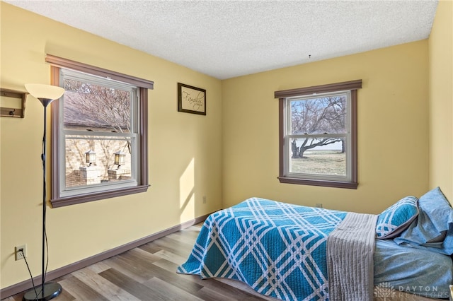 bedroom featuring hardwood / wood-style flooring and a textured ceiling