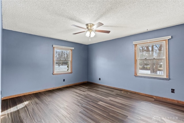 spare room with ceiling fan, wood-type flooring, and a textured ceiling