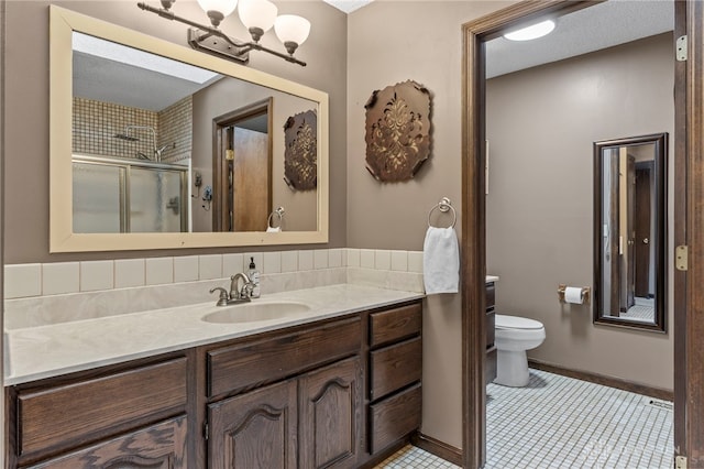 bathroom with vanity, a notable chandelier, toilet, a shower with door, and tile patterned floors