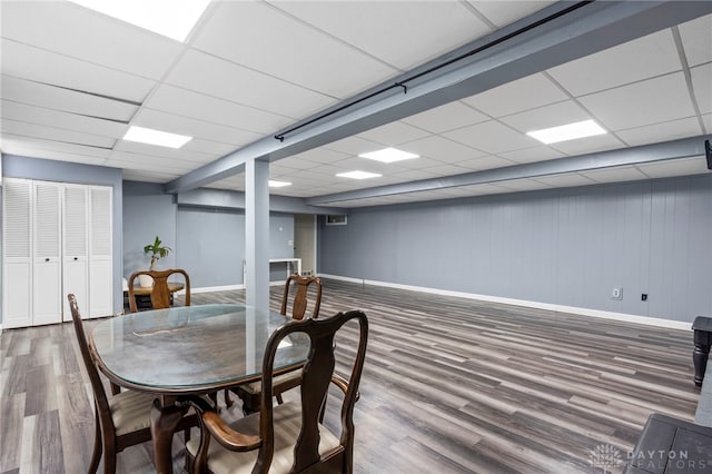 dining room featuring a paneled ceiling and hardwood / wood-style floors