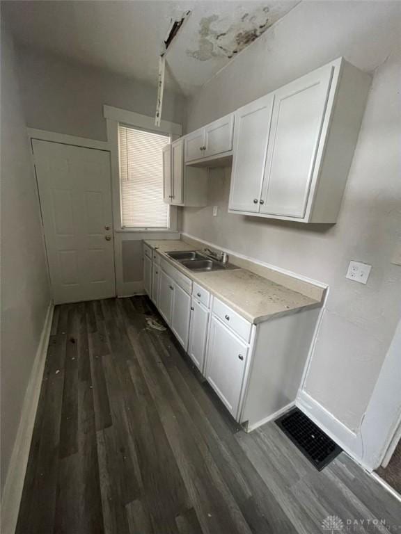 kitchen featuring white cabinetry, sink, and dark hardwood / wood-style flooring