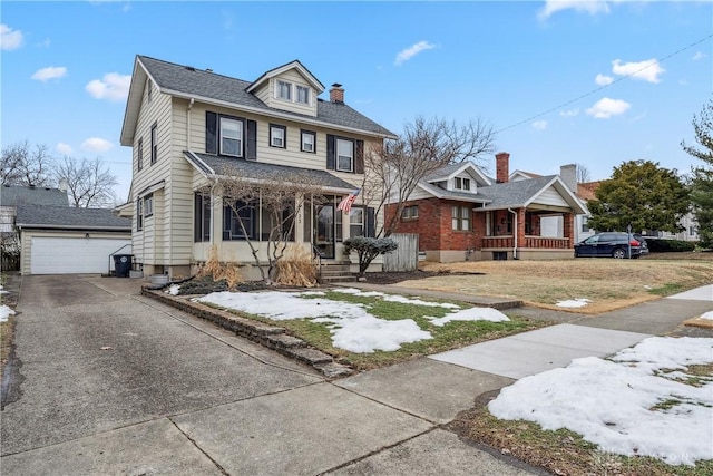 view of front of home featuring an outbuilding, a garage, and covered porch