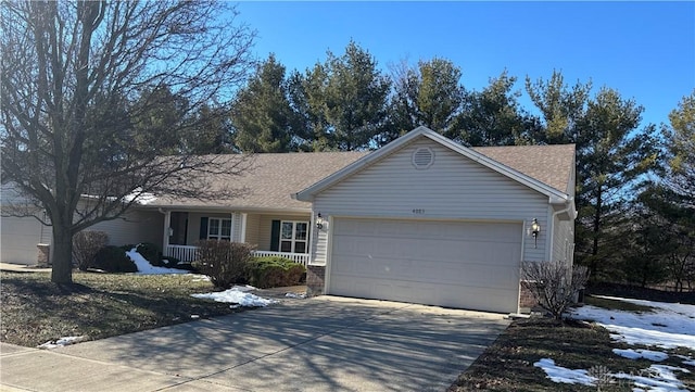 single story home featuring a garage and covered porch