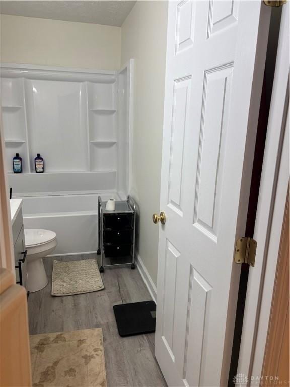 bathroom with vanity, hardwood / wood-style flooring, and toilet