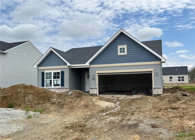 1268 Timber Glen Dr, Wilmington, OH 45177 - view of front of house with a shingled roof, stone siding, and a garage
