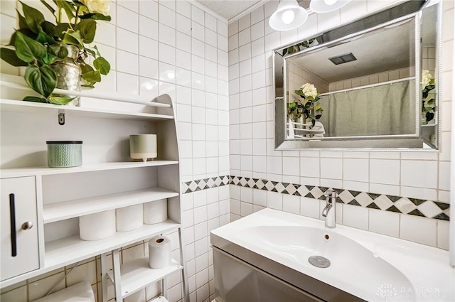 bathroom with vanity, tile walls, and decorative backsplash