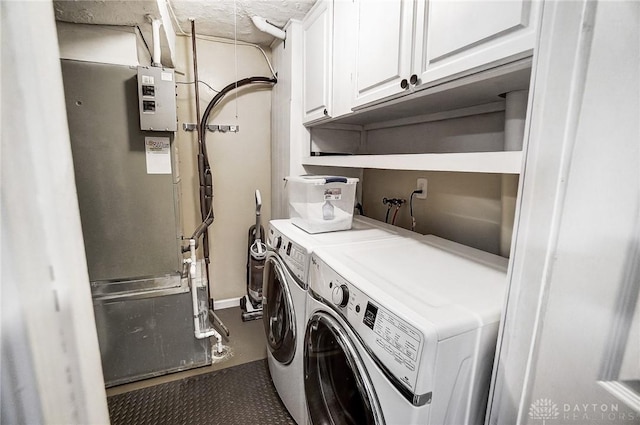 washroom featuring cabinets and separate washer and dryer