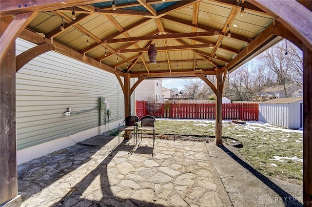 view of patio / terrace with a gazebo and a shed