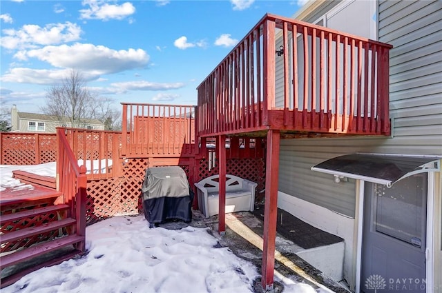 snow covered deck with area for grilling