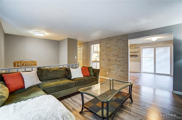 living room with hardwood / wood-style flooring and sink