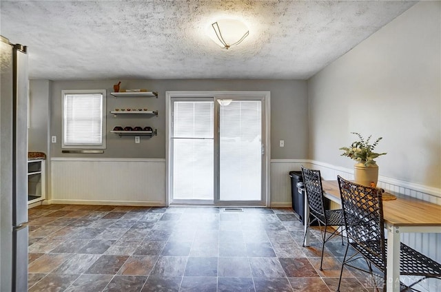 dining room with a textured ceiling