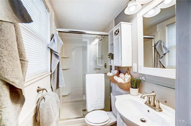 bathroom with vanity, a shower with door, and toilet