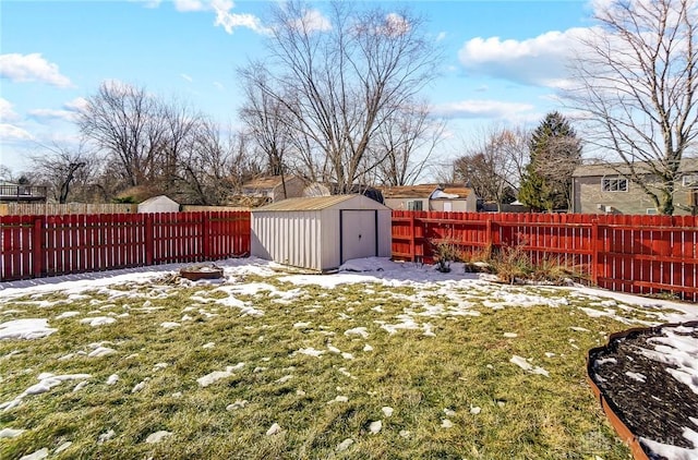 yard layered in snow with a shed