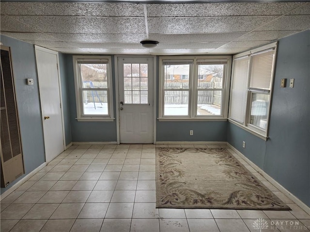 entryway featuring light tile patterned flooring and a drop ceiling