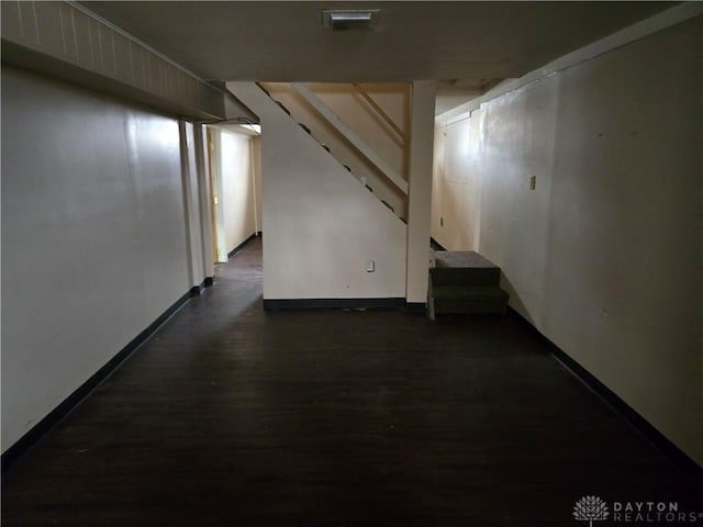 basement featuring dark hardwood / wood-style flooring