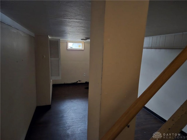 corridor with dark hardwood / wood-style flooring