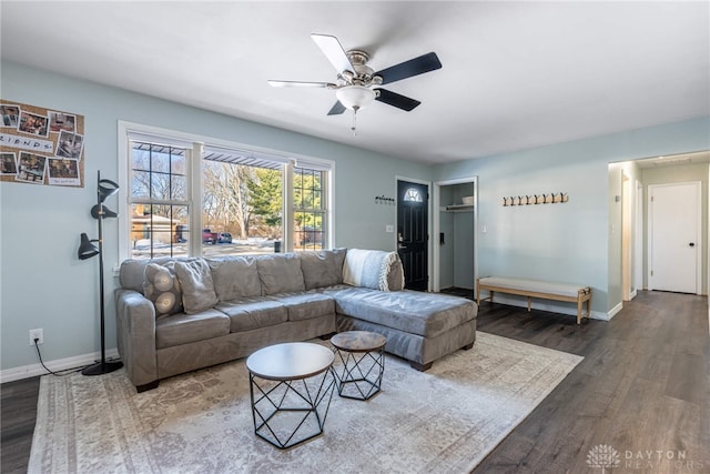 living area featuring ceiling fan, baseboards, and wood finished floors