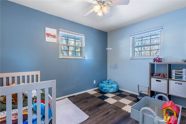 bedroom featuring a ceiling fan, baseboards, and dark wood-style flooring