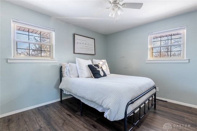 bedroom featuring dark wood-style floors, a ceiling fan, and baseboards