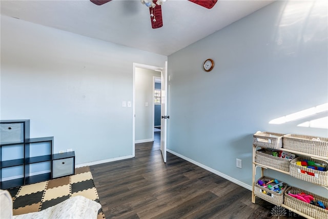 interior space with dark wood-style floors, ceiling fan, and baseboards