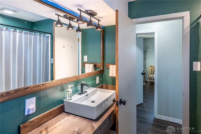 bathroom with wood finished floors and vanity