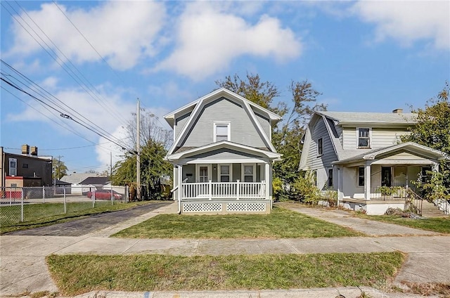 view of front of house featuring covered porch and a front yard