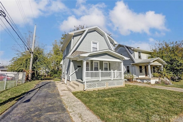 view of front facade with covered porch and a front yard