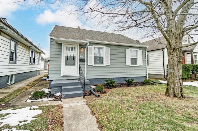 bungalow-style home with a front lawn