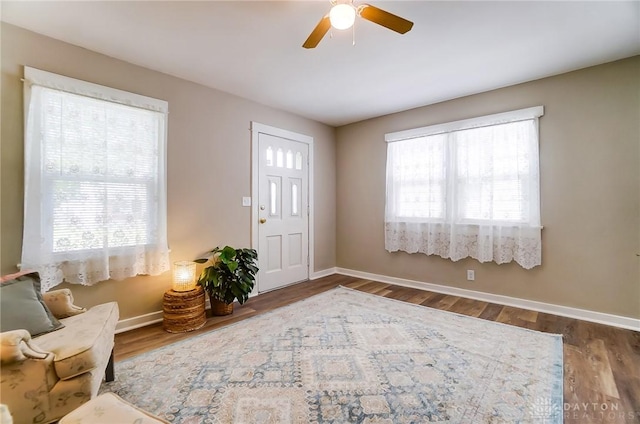 foyer with dark hardwood / wood-style flooring and ceiling fan