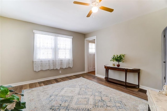 interior space featuring dark wood-type flooring and ceiling fan