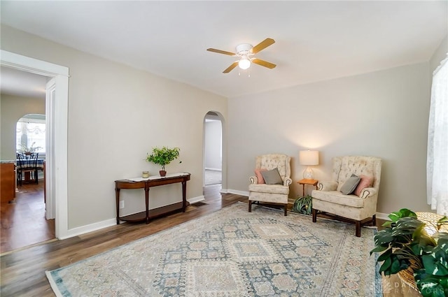 living area featuring wood-type flooring and ceiling fan