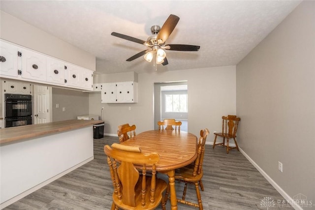 dining room with ceiling fan and light hardwood / wood-style floors