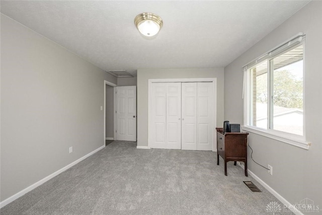 carpeted bedroom with a closet