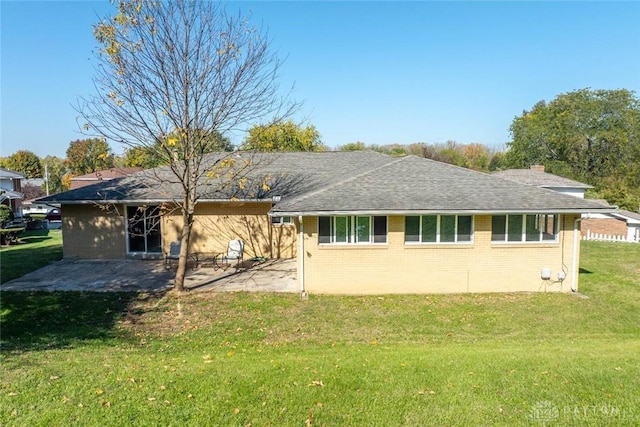 rear view of property with a patio area and a lawn