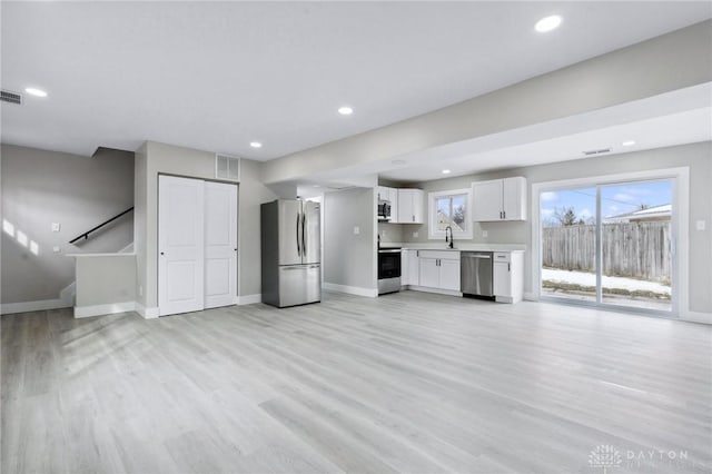 unfurnished living room with light wood-type flooring