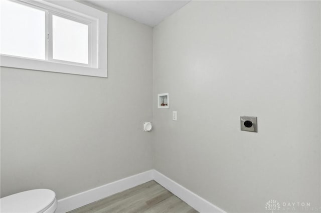 laundry room with hookup for a washing machine, light hardwood / wood-style flooring, and electric dryer hookup