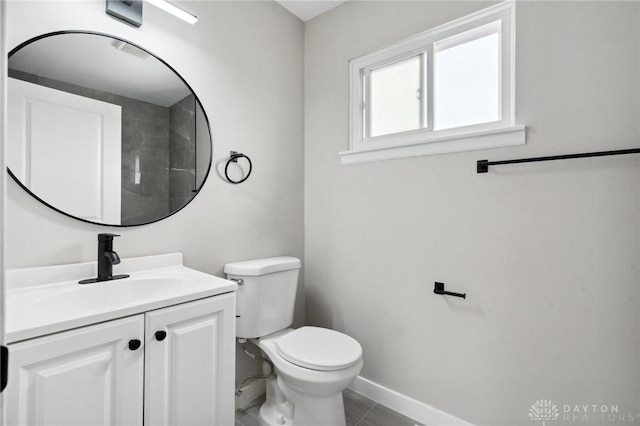 bathroom featuring vanity, tile patterned flooring, and toilet