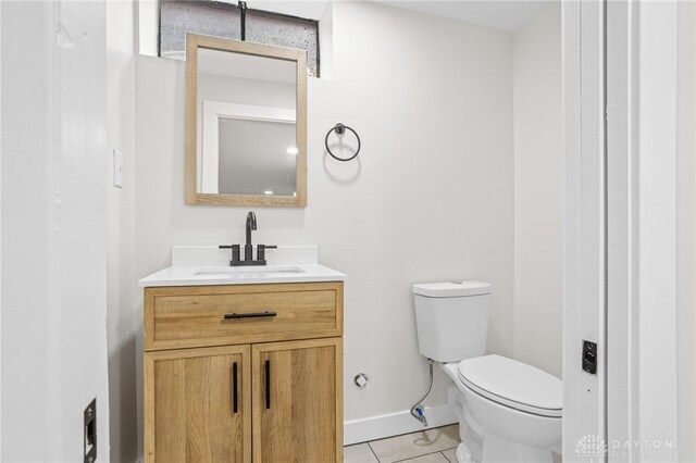 bathroom featuring tile patterned floors, toilet, and vanity