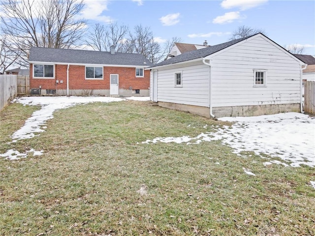 back of property featuring a lawn