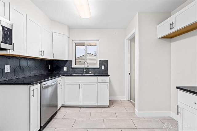 kitchen with white cabinetry, sink, tasteful backsplash, and appliances with stainless steel finishes