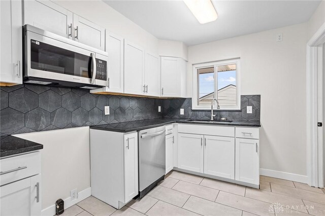 kitchen featuring sink, stainless steel appliances, and white cabinets