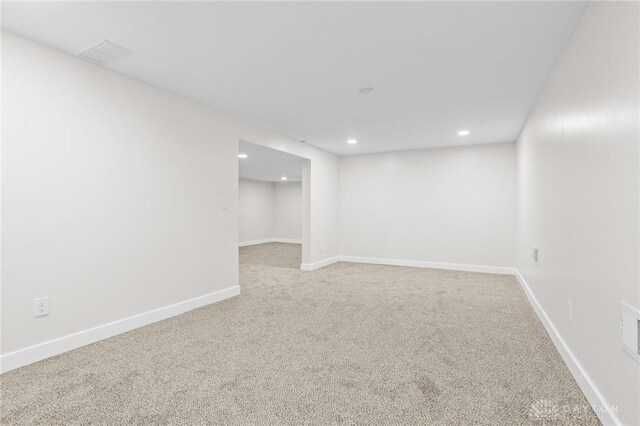 basement featuring light colored carpet