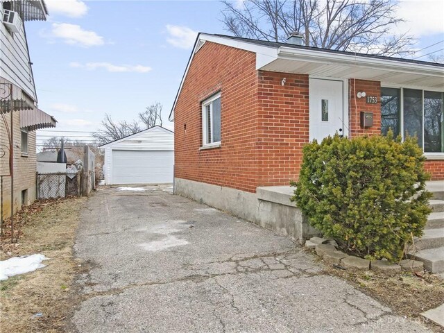 view of side of home with a garage and an outdoor structure