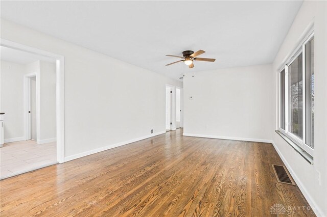 unfurnished room with ceiling fan and light hardwood / wood-style floors