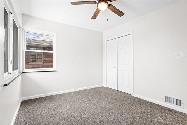 unfurnished bedroom with carpet floors, a closet, and ceiling fan