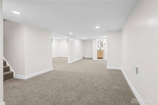 basement featuring light colored carpet